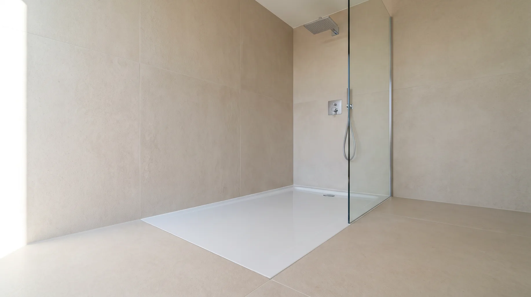 Finished level-access wet room with an ultra-flat Bette steel shower tray sitting flush with large-format porcelain flooring