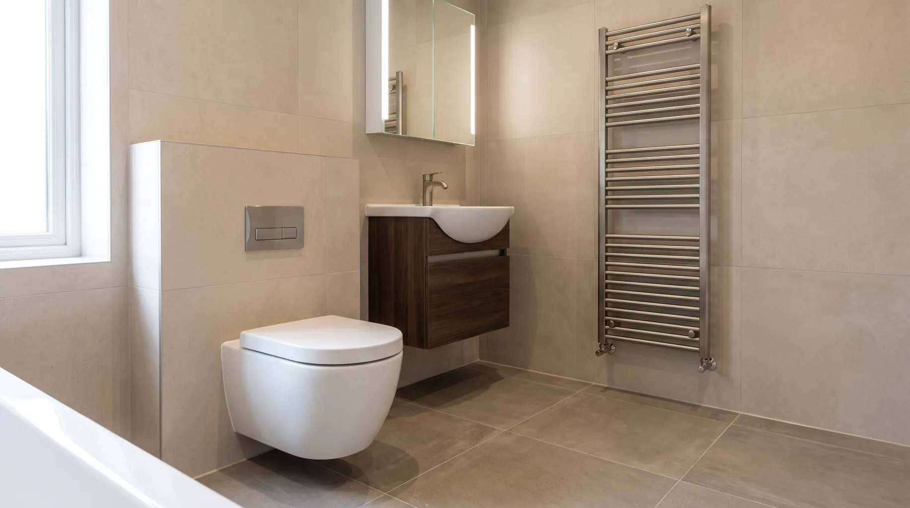 Finished bathroom with a wall-hung ceramic WC and wall-mounted basin on vanity furniture, Villeroy & Boch-style sanitaryware
