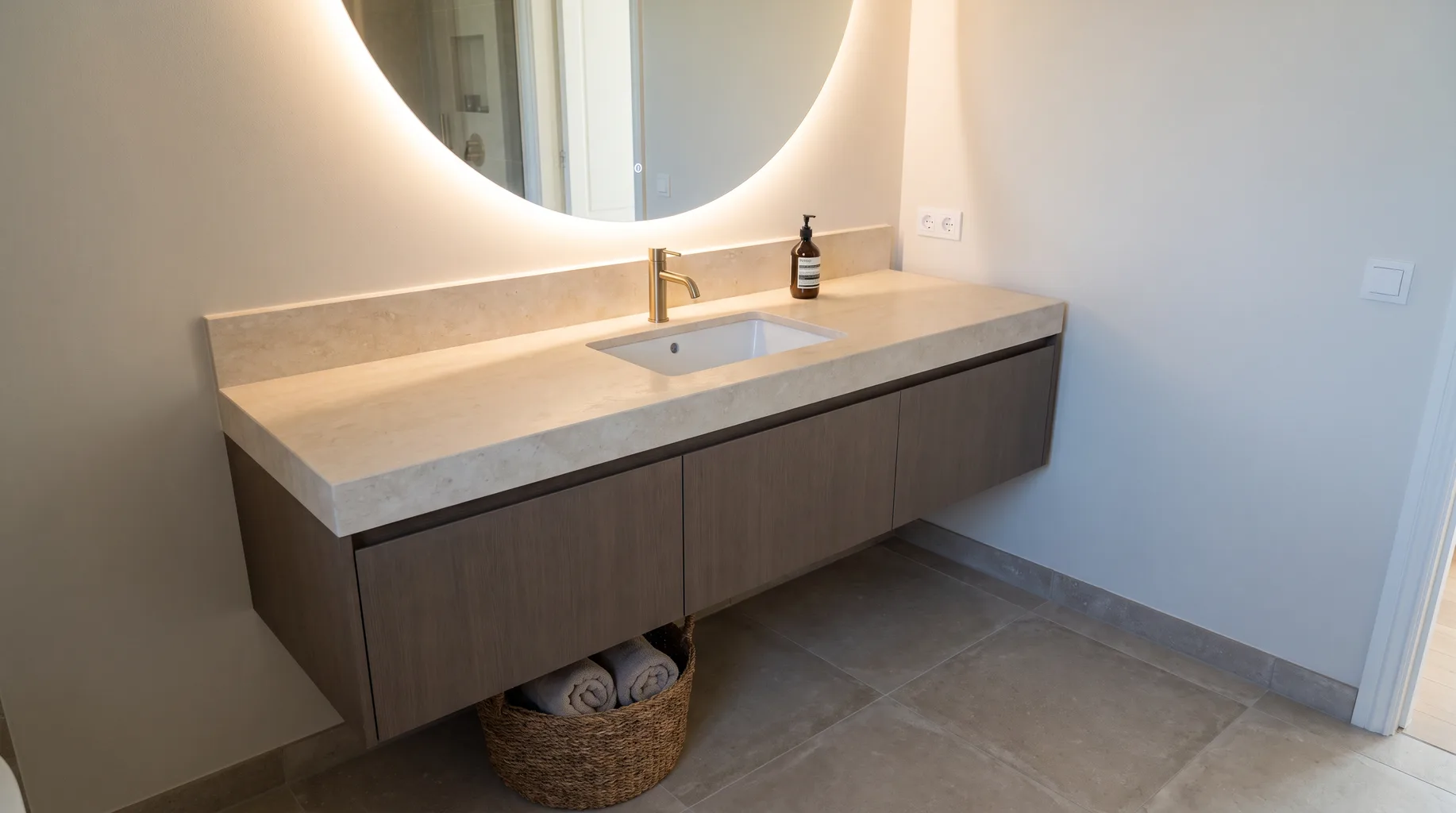Finished wall-hung vanity unit with stone countertop, inset basin and illuminated mirror