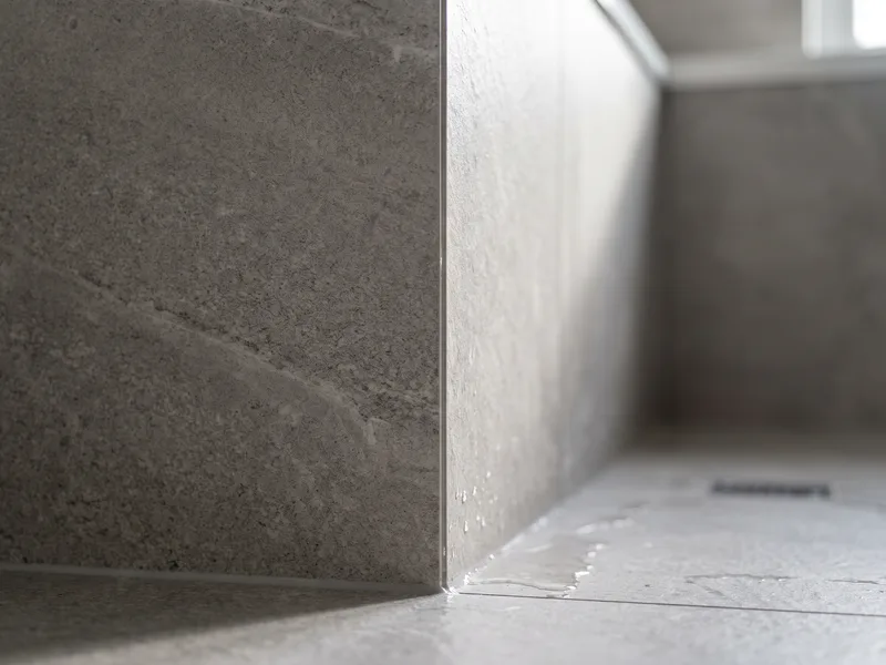 Macro detail of a mitred tiled corner with identical tone and finish continuing unbroken across both faces