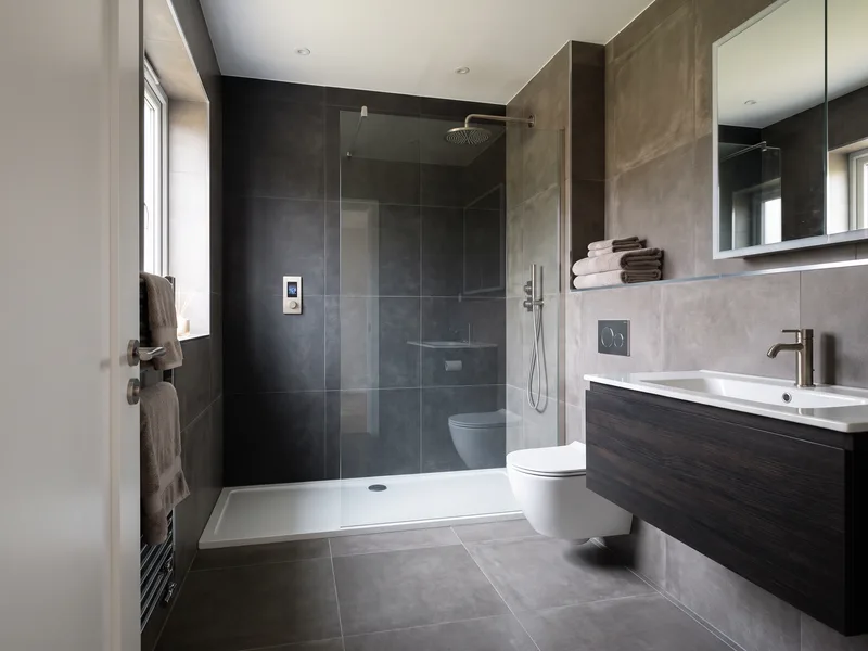 Finished contemporary bathroom with a digital shower panel and large-format matte porcelain in a Bracknell executive-style home