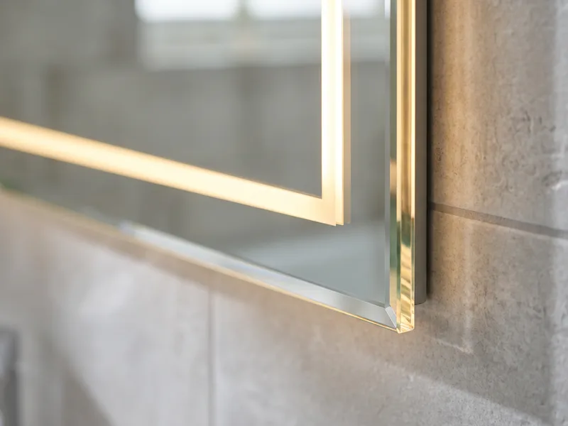 Close-up of an illuminated mirror's edge lighting