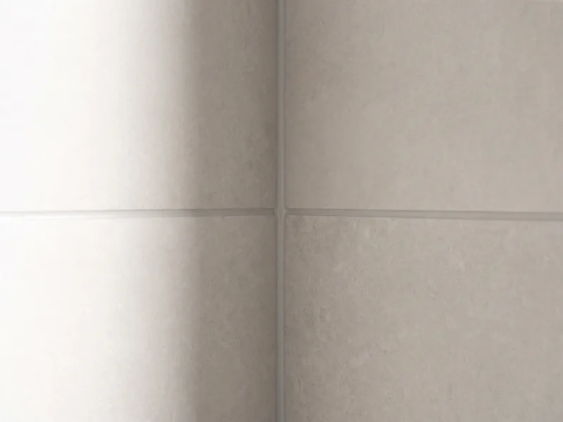 Close detail of tile joints lining through precisely at an internal corner in a finished bathroom