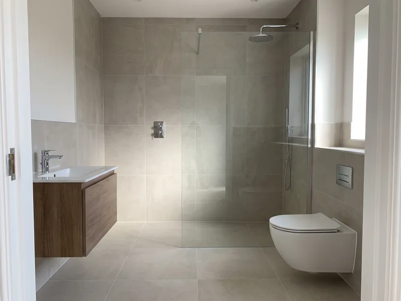 Finished luxury family bathroom with a walk-in shower and wall-hung WC in Sandhurst
