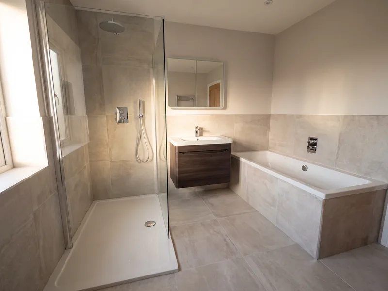 Finished luxury family bathroom with a built-in bath and walk-in shower in a Twyford home