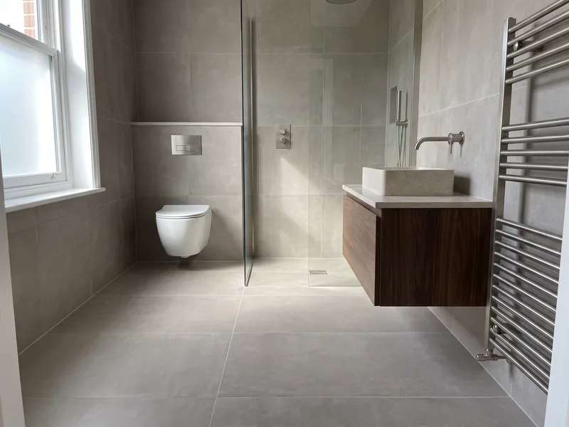 Finished luxury bathroom in a Wokingham townhouse conversion with a stone-effect floating vanity and concealed-cistern WC